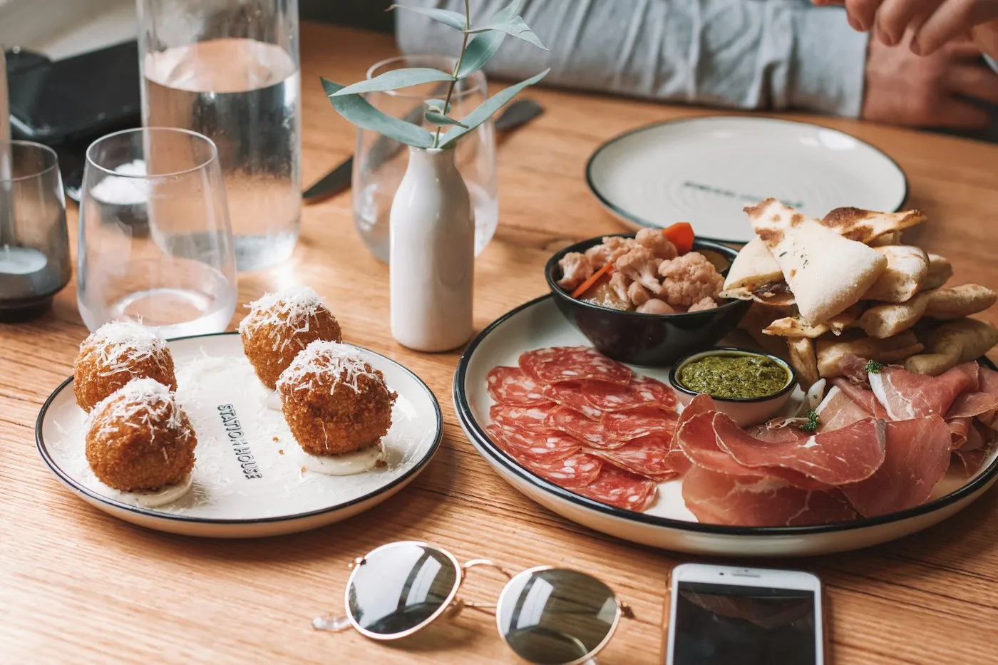 Croquettes, cured meats and bread laid out to share